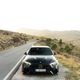 2023 mercedes-amg c 63 s e-performance in matte black photographed on the side of a mountain road in spain